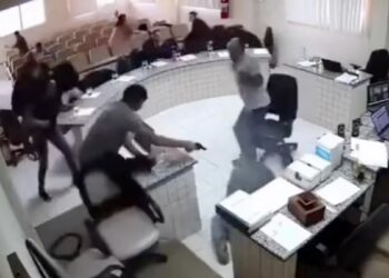 Shocking moment furious son fires six shots at his father’s alleged killer in Brazilian court before pistol-whipping him