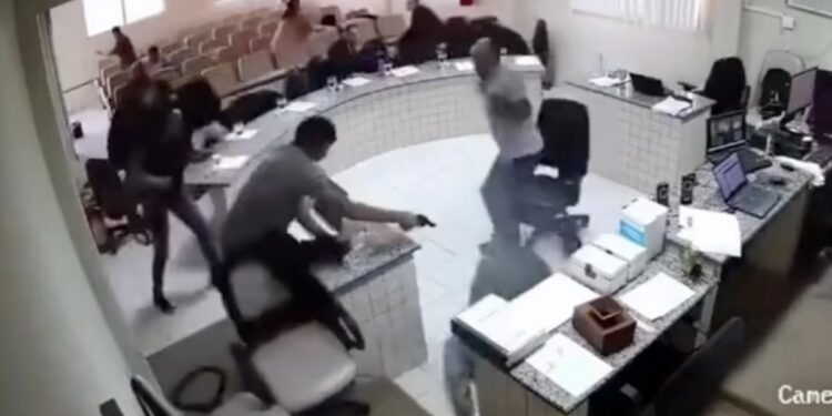 Shocking moment furious son fires six shots at his father’s alleged killer in Brazilian court before pistol-whipping him